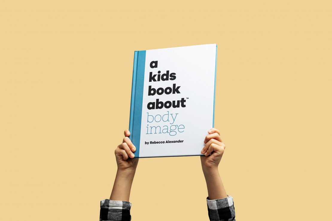 arms holding up A Kids Book About Body Image by Rebecca Alexander