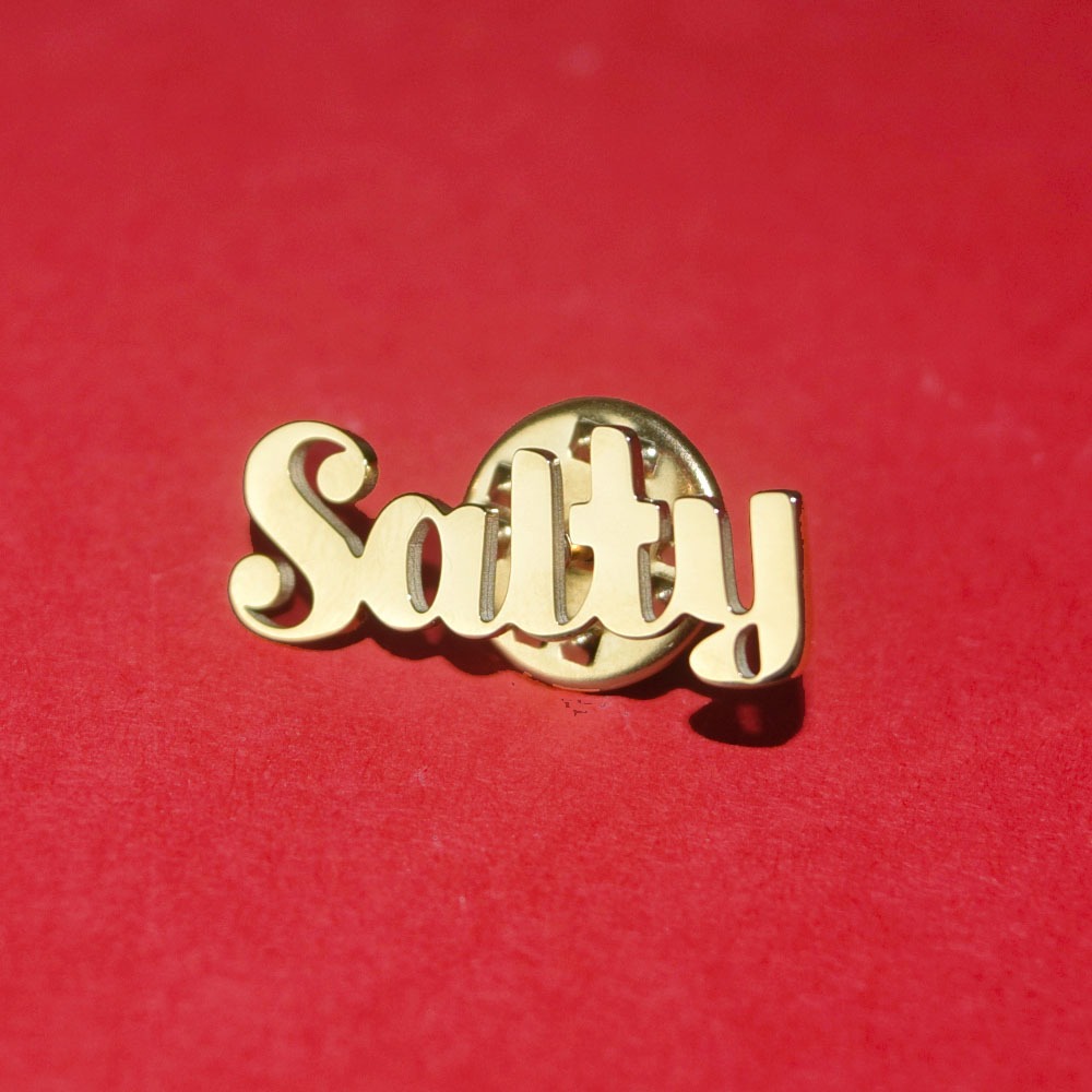 salty logo as a gold pin